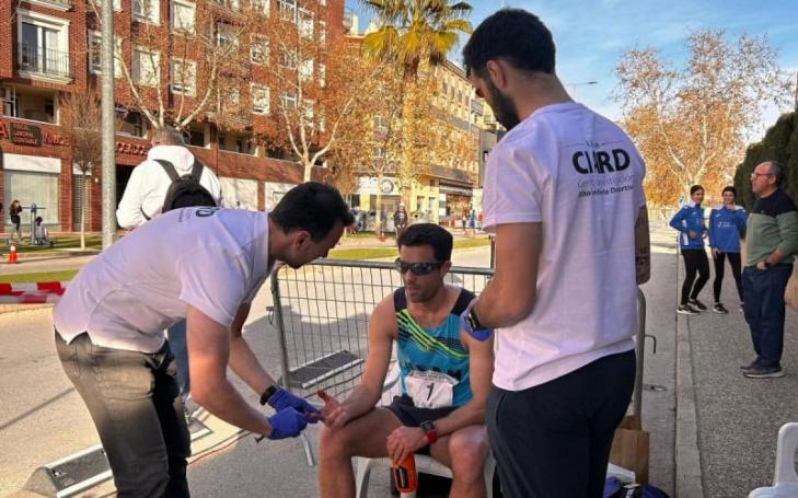 Technicians from the UCAM Research Centre for High Performance Sport (CIARD) taking a blood sample from Miguel Ángel López during the Regional Championship held in Jumilla.