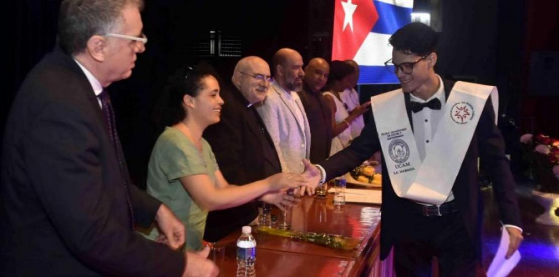 One of the graduating students is congratulated by the members of the Presidential Board.