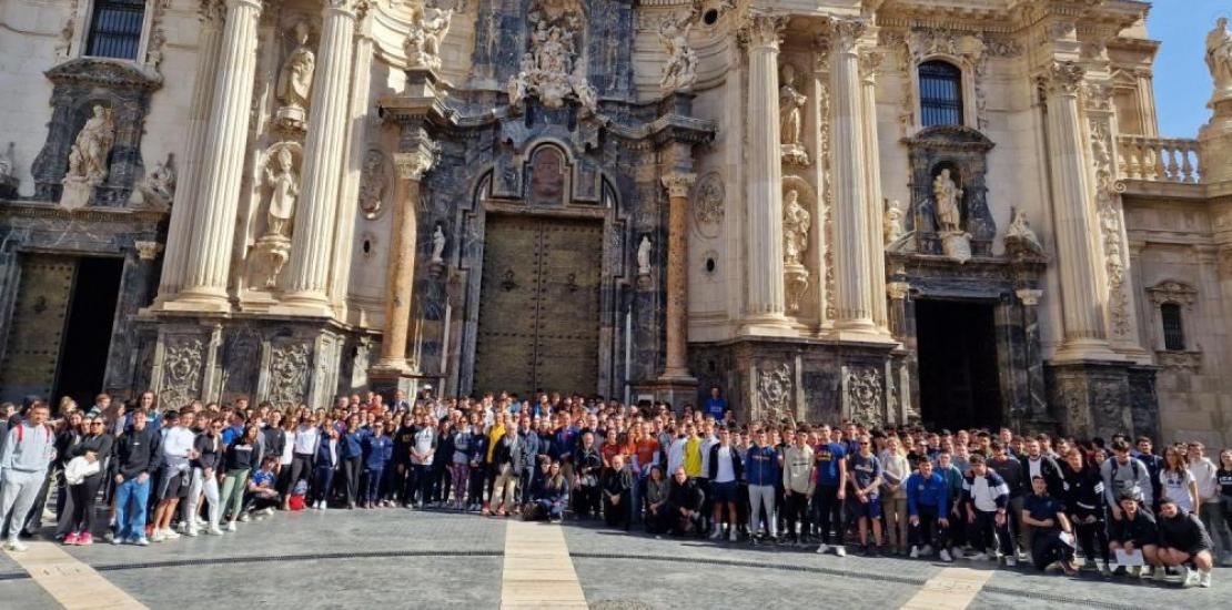 Group photo in front of the baroque façade of the Cathedral of Murcia with the pilgrims from the Faculty of Sport and the UCAM Polytechnic School