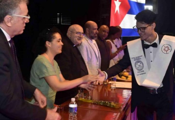 One of the graduating students is congratulated by the members of the Presidential Board.