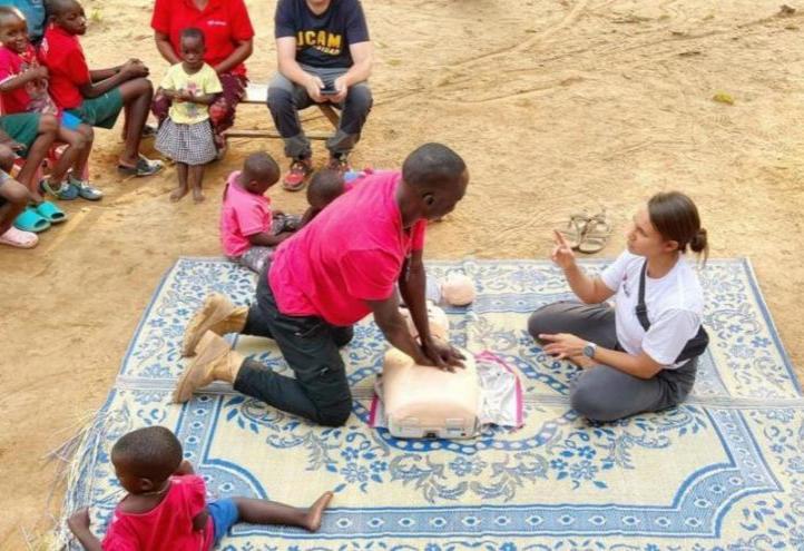 Members of the humanitarian expedition team teach CPR techniques to inhabitants of the Kikaya area, Uganda.